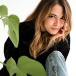 Headshot of a smiling woman in her forties with a natural look.
